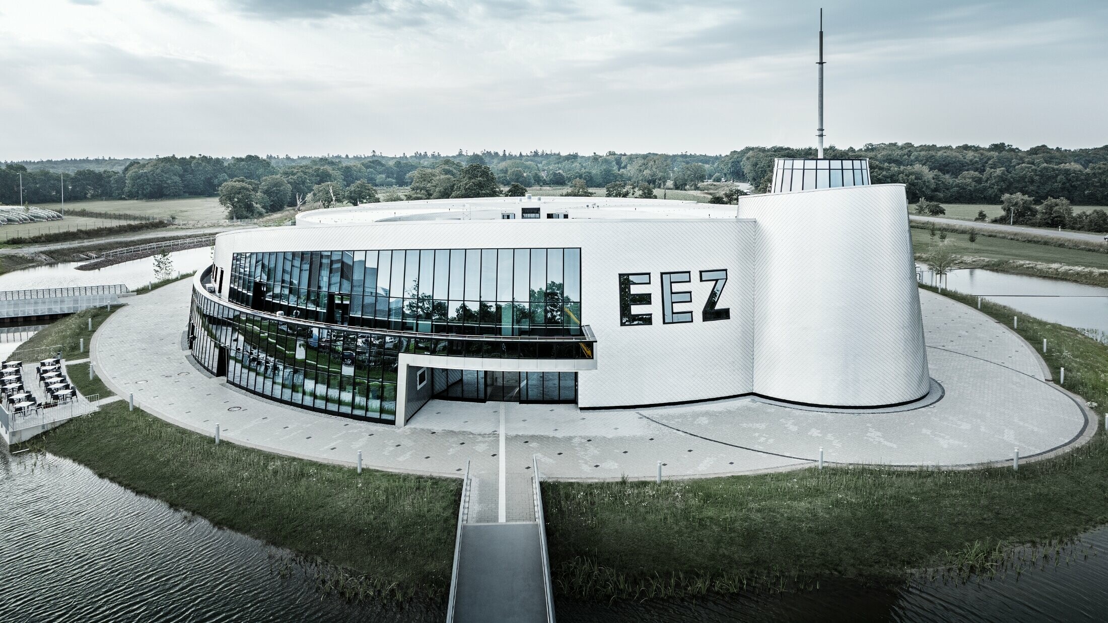 Številni zaobljeni deli zgradbe Doživljajskega centra za energijo v kraju Aurich (Energie-Erlebnis-Zentrum – EEZ) so bili oblečeni s fasadnim rombom 20 x 20 PREFA v barvi naravnega aluminija.