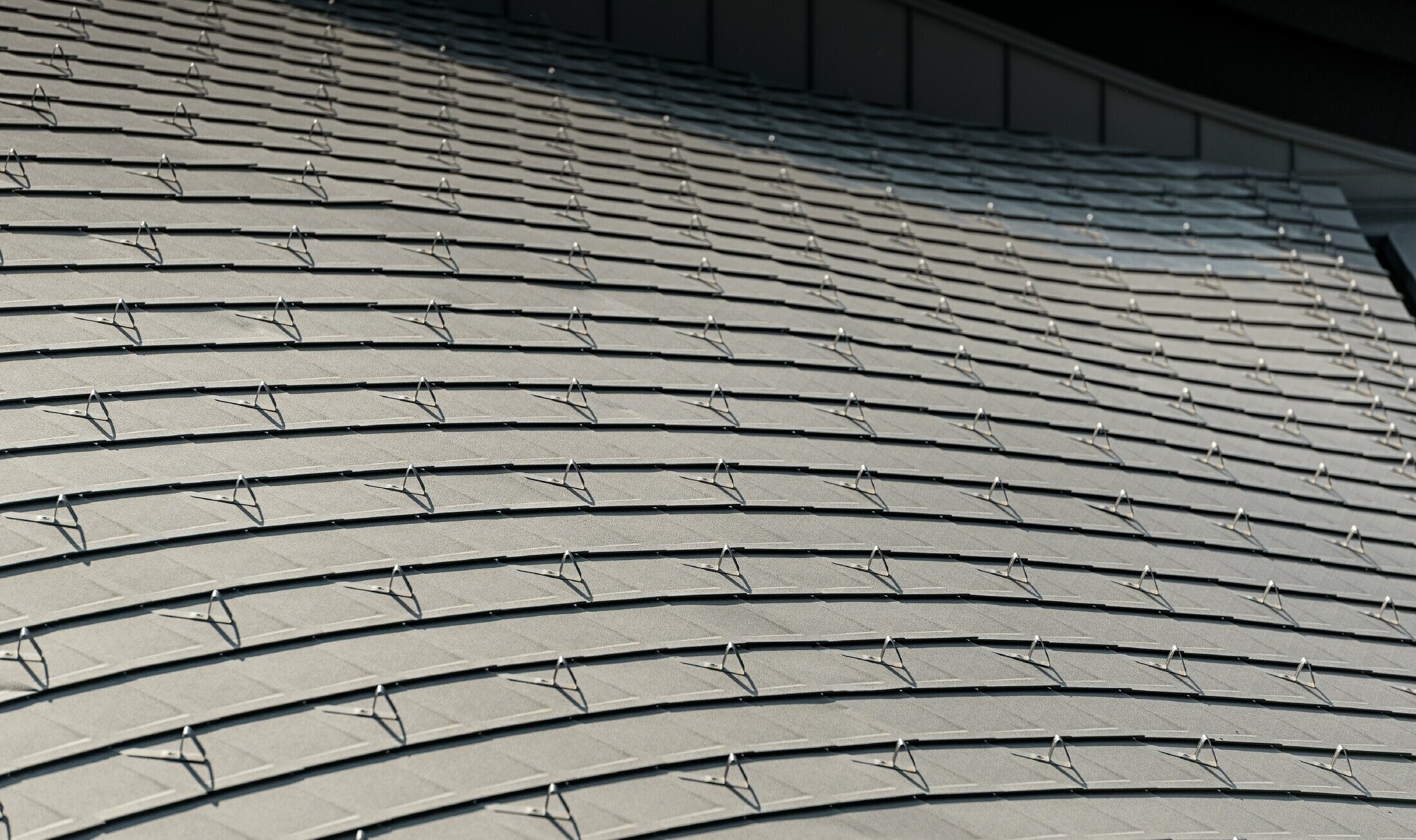 Stavba v golf letovišču Varignano z dolgo aluminijasto streho PREFA v rjavi barvi