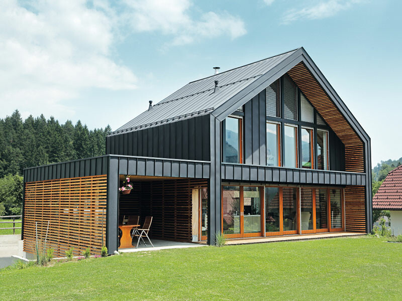 Stanovanjska hiša s prilagodljivo in vzdržljivo streho in fasadno oblogo PREFA iz aluminija v antracitni barvi.