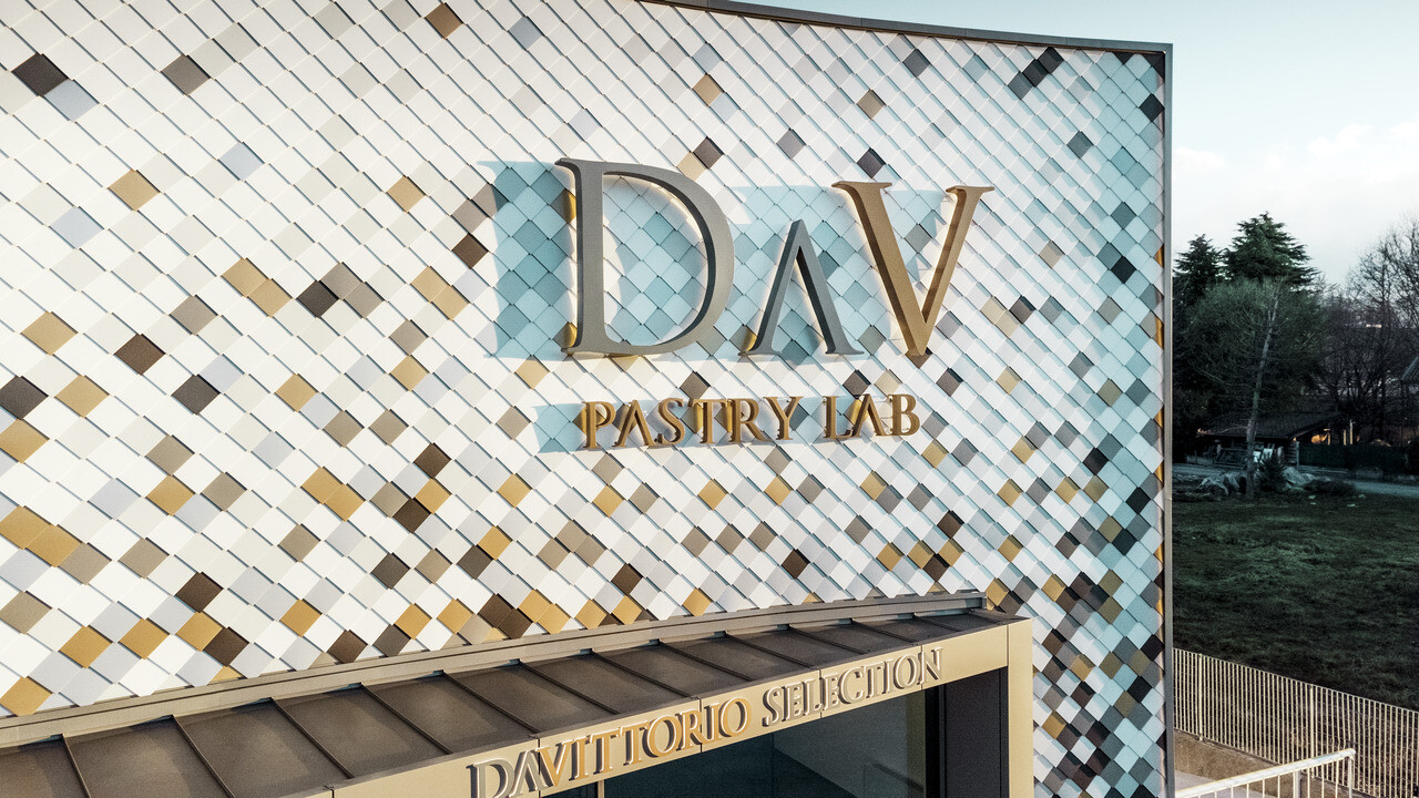 Poslovna zgradba podjetja Pastry Lab v kraju Bergamo z razgibano fasado iz fasadnih rombov v barvah P.10 anodik rjava, bronasta, P.10 temnosiva, mayagold, naravni aluminij, P.10 prefa bela in P.10 bela 