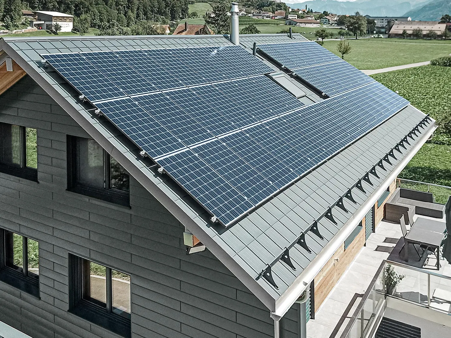 Fotonapetostni sistem, montiran na strehi PREFA, z nosilci solarnih sistemov in nosilnim profilom za stabilno namestitev.